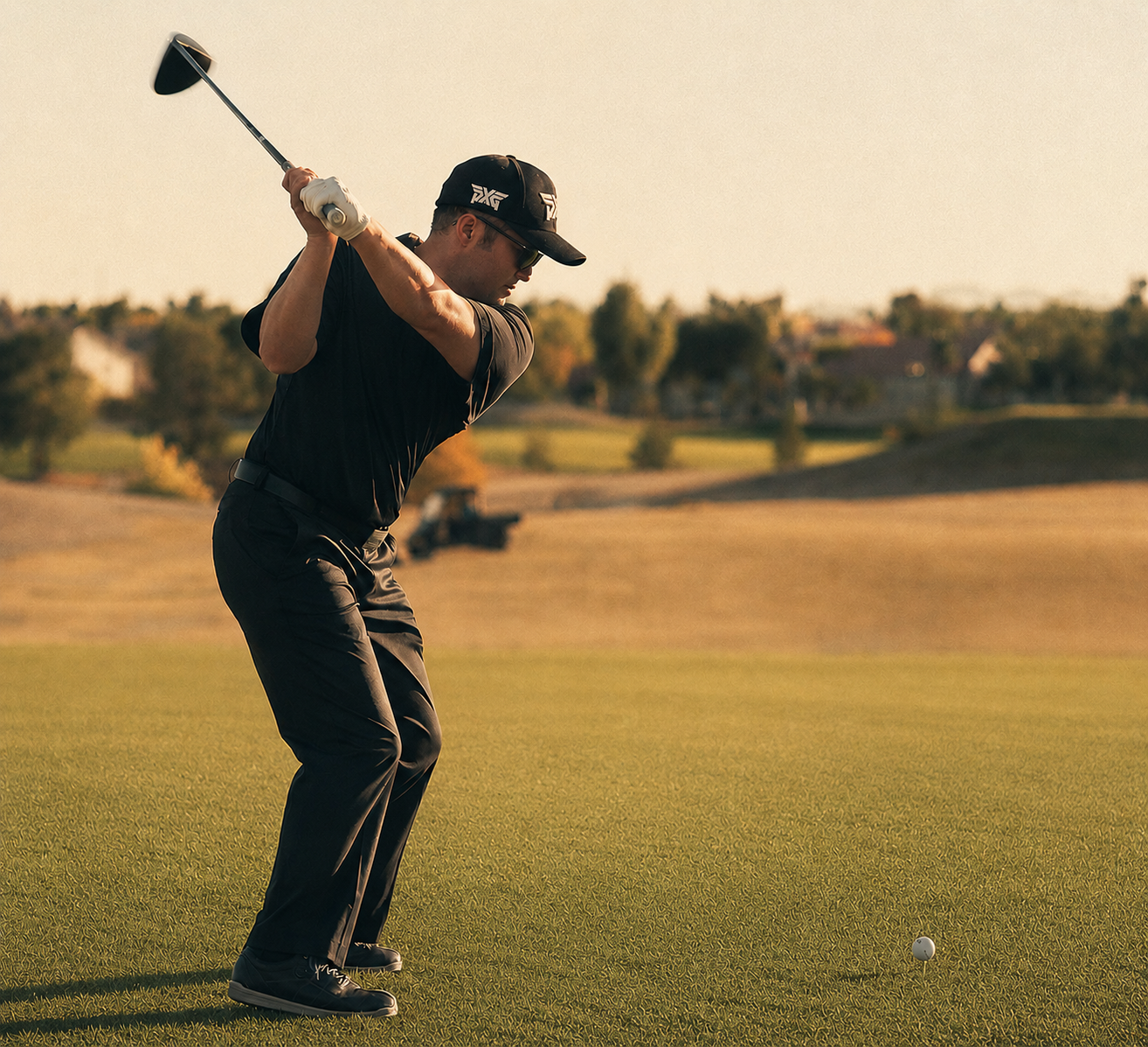 Tatsuro Oshimoto at the top of his backswing on a sunlit fairway.